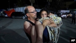 ایک فلسطینی غزہ کی پٹی پر اسرائیلی بمباری میں زخمی ہونے والی بچی کو الاقصیٰ اسپتال لے جارہا ہے۔ فوٹو رائٹرز
